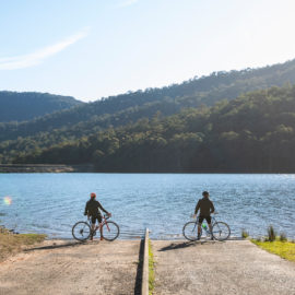 Cyclists by a lake near Cheshunt in the King Valley of Victoria's High Country
